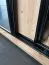 Kleiderschrank Mina in Eiche/Schwarz mit Schiebetüren, 1 Meter breit, ausziehbare Metallstangen, Lamellen aus Kunststoff, viel Stauraum, moderne Optik